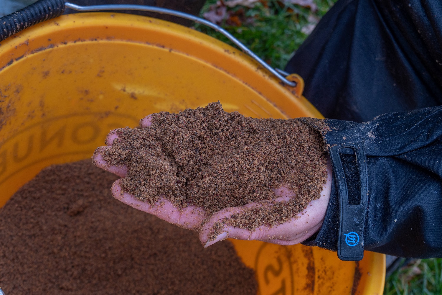 Des grabbing some of his finished bait mix solutin